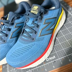 New Balance Men's Blue Athletic Shoes with Yellow and Red Accents 9.5